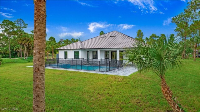 3660 4th Ave NE, Naples, FL 34120 - back of property with metal roof, fence, a fenced in pool, a standing seam roof, and a yard