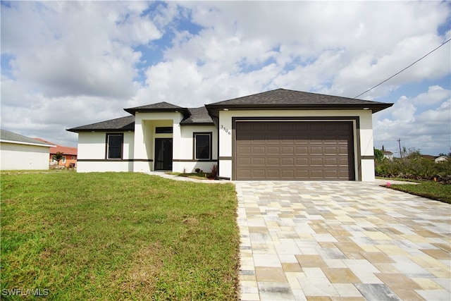 prairie-style house with a garage and a front lawn