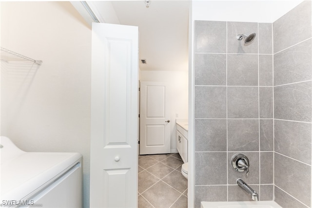 full bathroom with toilet, tile patterned flooring, vanity, washer / clothes dryer, and tiled shower / bath