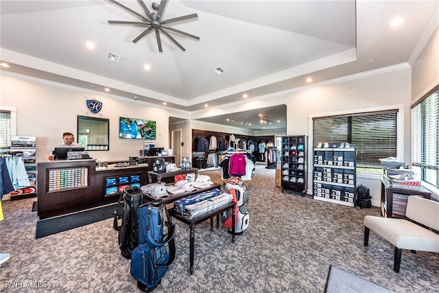 interior space featuring a tray ceiling, carpet flooring, ceiling fan, and ornamental molding