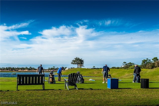 view of community featuring a water view and a yard