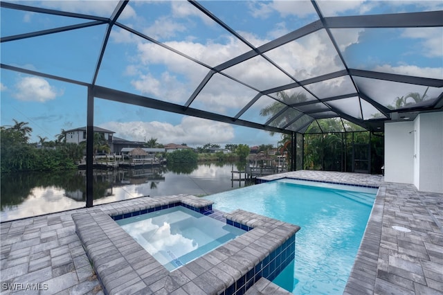 view of swimming pool with a patio, an in ground hot tub, a water view, and glass enclosure