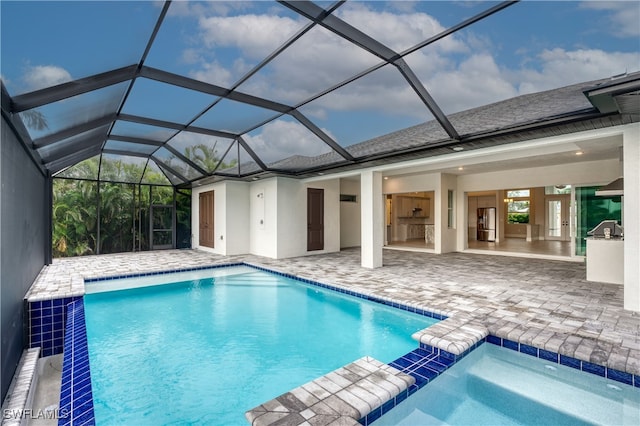 view of swimming pool featuring a patio area and a lanai