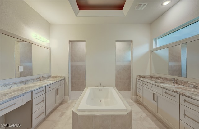 bathroom featuring vanity, shower with separate bathtub, and a tray ceiling