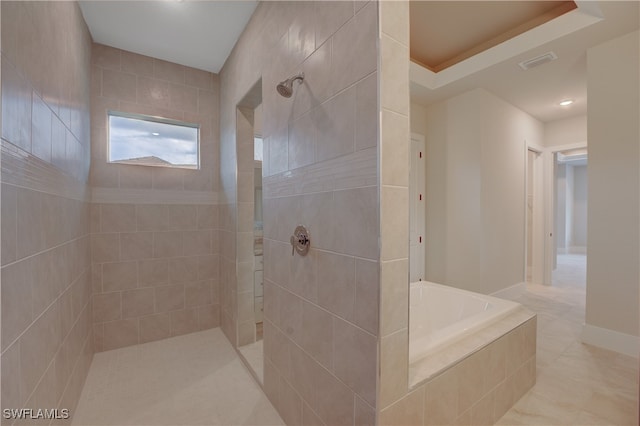 bathroom featuring a tray ceiling and plus walk in shower