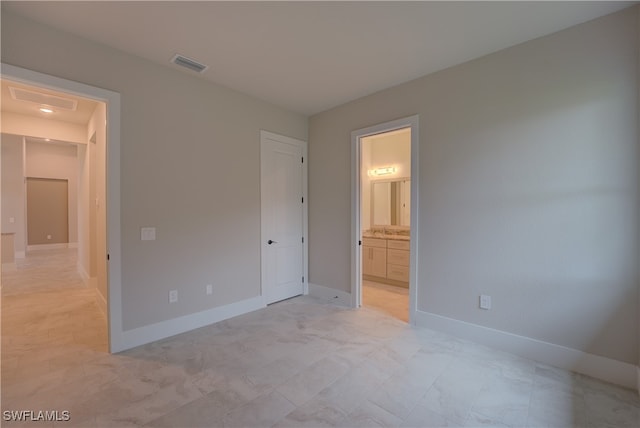 unfurnished bedroom featuring connected bathroom