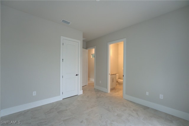 unfurnished bedroom featuring ensuite bath