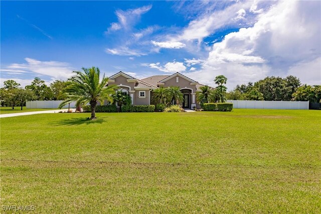 ranch-style home featuring a front lawn