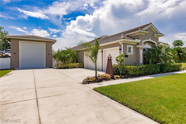 view of front of house with a garage and a front lawn