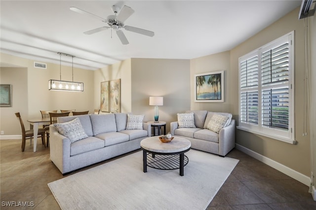 tiled living room featuring ceiling fan