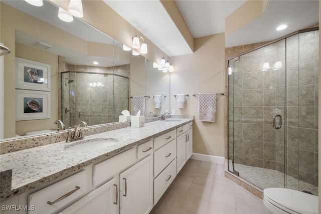 bathroom featuring a stall shower, a sink, baseboards, and double vanity