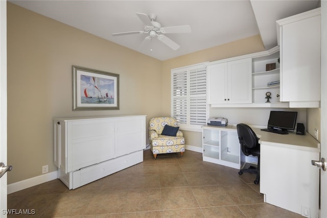 office space with tile patterned flooring, ceiling fan, and built in desk