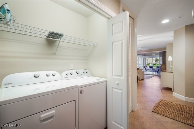 laundry room with ceiling fan, light tile patterned flooring, and washer and clothes dryer