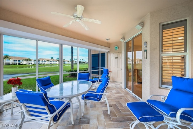 sunroom featuring ceiling fan