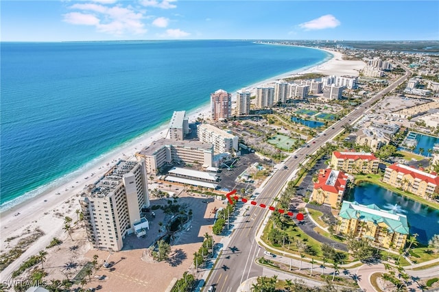 birds eye view of property with a beach view and a water view