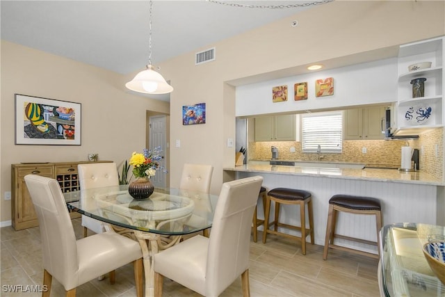 dining area with light tile patterned floors and visible vents