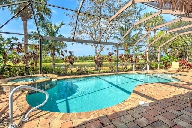 view of pool with a lanai, a patio, and an in ground hot tub