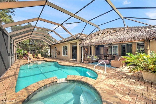 view of pool featuring an in ground hot tub, a patio, an outdoor living space, and glass enclosure