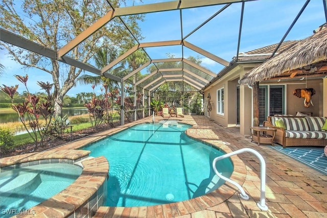 view of swimming pool featuring glass enclosure, a water view, an in ground hot tub, and a patio