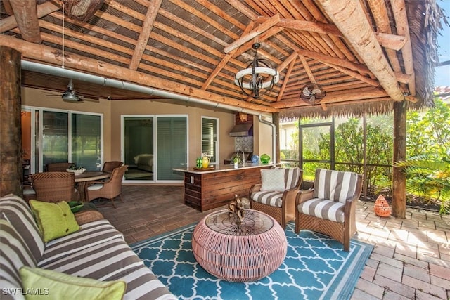 sunroom featuring ceiling fan and lofted ceiling