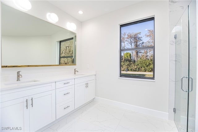 bathroom with a shower with door and vanity