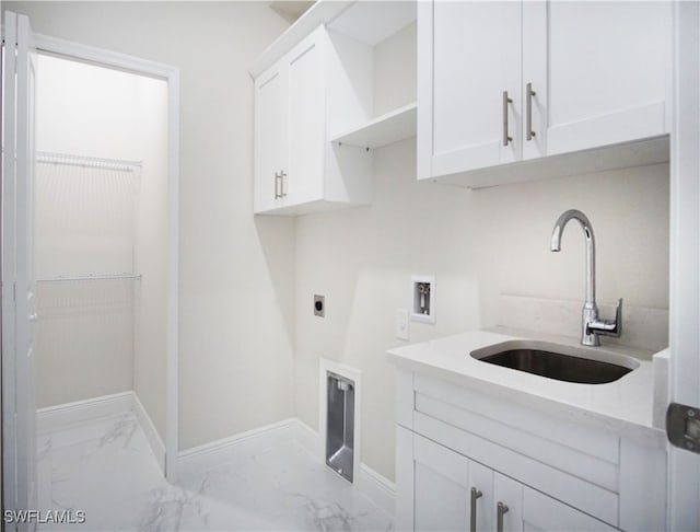 washroom featuring hookup for an electric dryer, cabinets, sink, and washer hookup