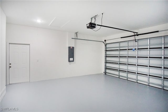 garage with a garage door opener and electric panel