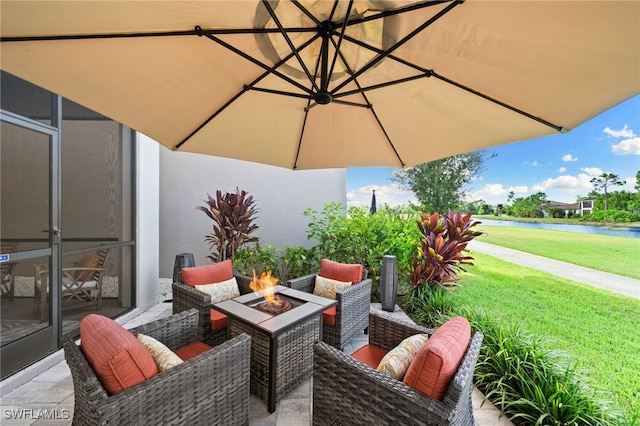 view of patio with an outdoor living space with a fire pit