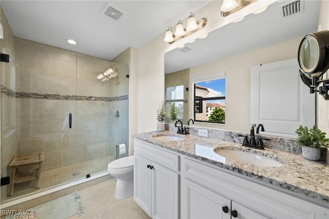 bathroom with vanity, toilet, tile patterned flooring, and a shower with door