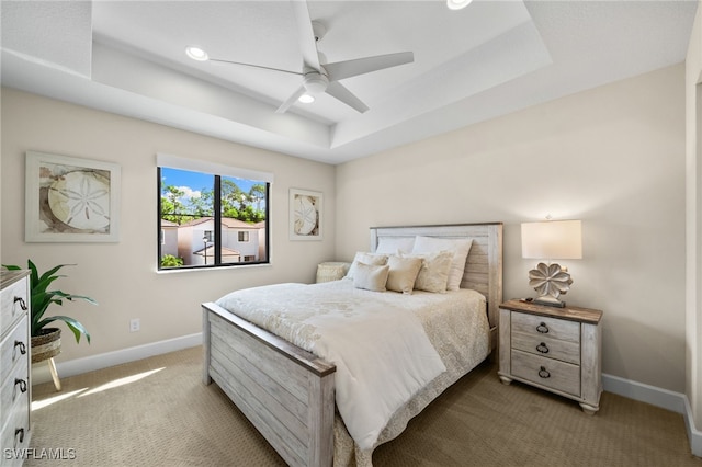 bedroom featuring a tray ceiling, ceiling fan, and carpet floors