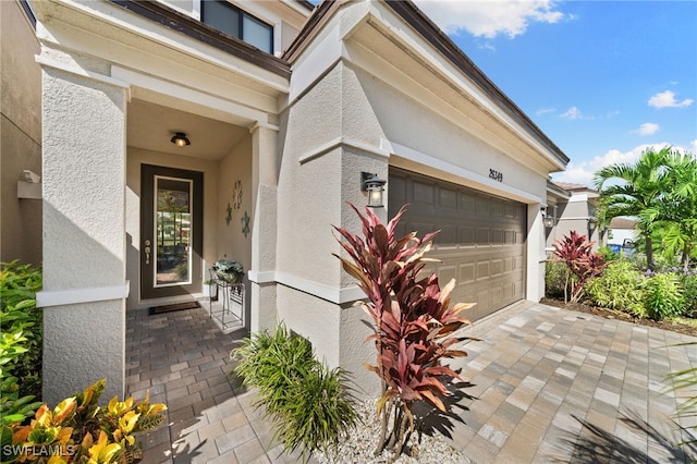 26349 Bonita Fairways Blvd, Bonita Springs, FL 34135 - property entrance featuring an attached garage and stucco siding