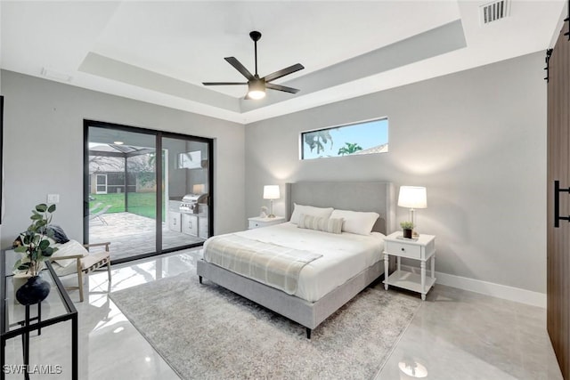 bedroom with access to outside, multiple windows, and a raised ceiling