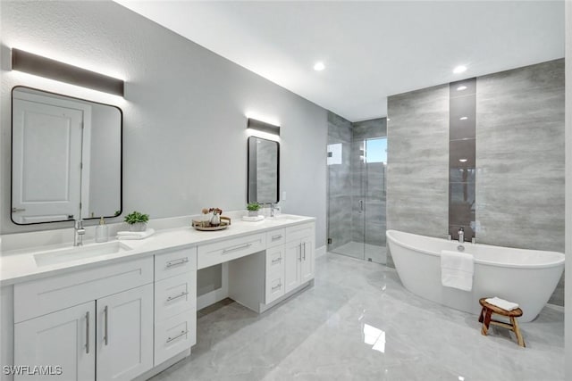 full bathroom featuring marble finish floor, a sink, a shower stall, and double vanity