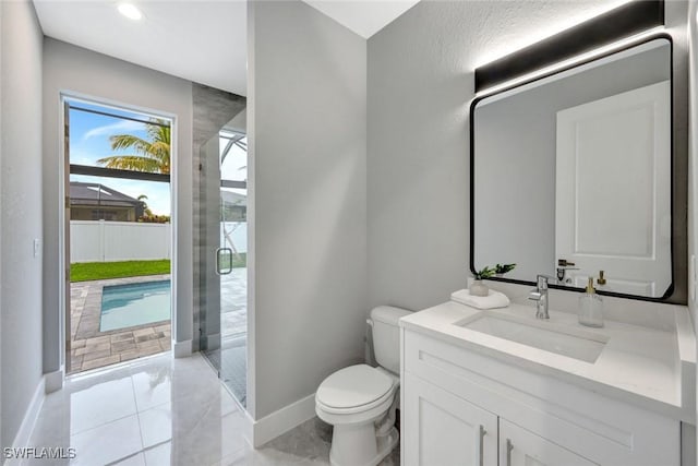 full bathroom featuring a stall shower, vanity, toilet, and baseboards