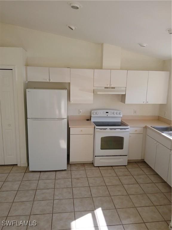 kitchen with white cabinets, white appliances, sink, and vaulted ceiling