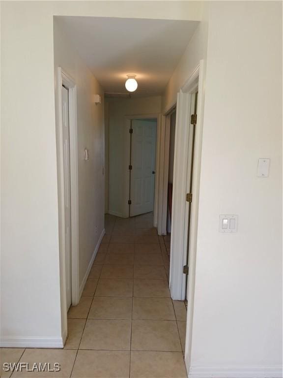 hall featuring light tile patterned floors