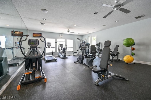 gym featuring ceiling fan and a textured ceiling