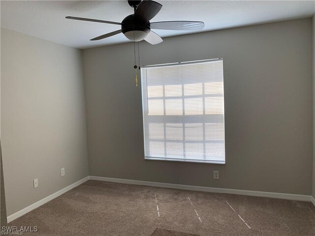 empty room featuring carpet floors and ceiling fan