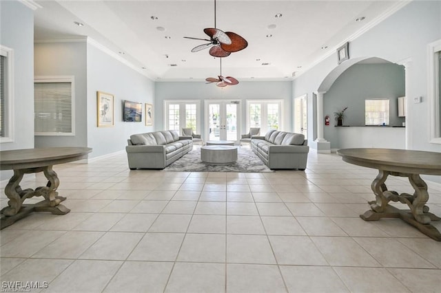 living room featuring a tray ceiling, ceiling fan, light tile patterned floors, and french doors