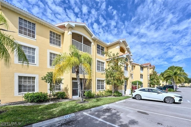 view of building exterior featuring uncovered parking