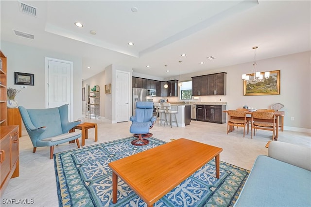 living area with recessed lighting, visible vents, baseboards, and an inviting chandelier