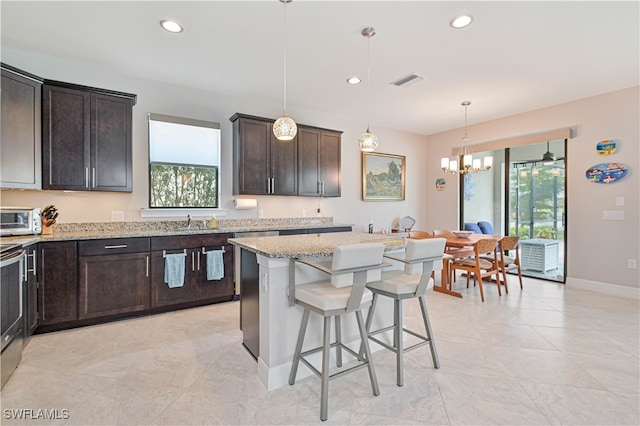 kitchen featuring a healthy amount of sunlight, light stone counters, and light tile patterned floors