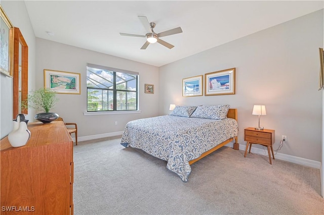 bedroom with light carpet, a ceiling fan, and baseboards