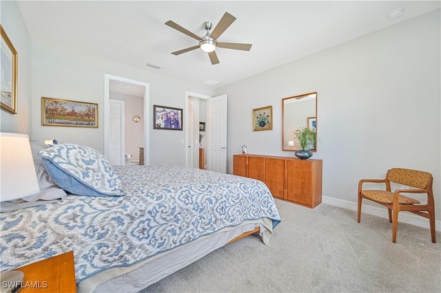 bedroom featuring baseboards, visible vents, ceiling fan, and light colored carpet