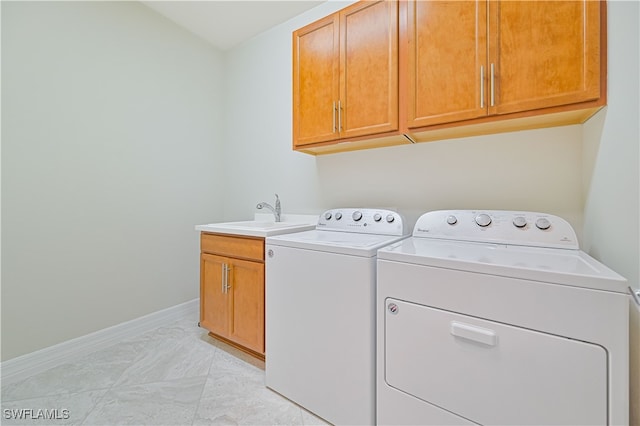 washroom with light tile patterned floors, cabinets, sink, and separate washer and dryer