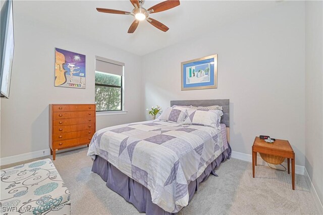 carpeted bedroom featuring ceiling fan and baseboards