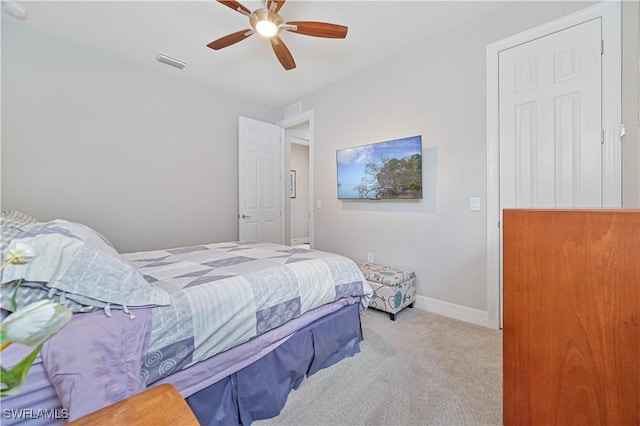 bedroom featuring a ceiling fan, baseboards, visible vents, and carpet flooring