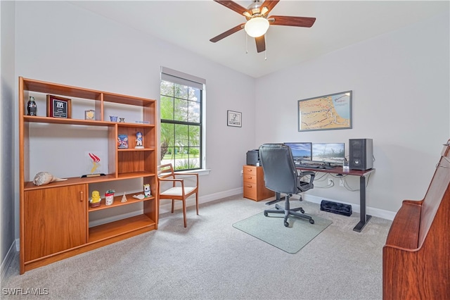 home office featuring ceiling fan and light carpet