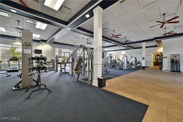 exercise room featuring a wealth of natural light, ceiling fan, and carpet