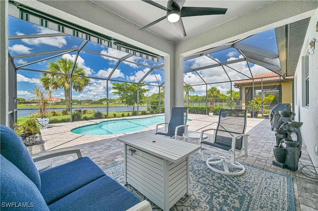 view of patio featuring a lanai, an outdoor pool, a ceiling fan, and area for grilling